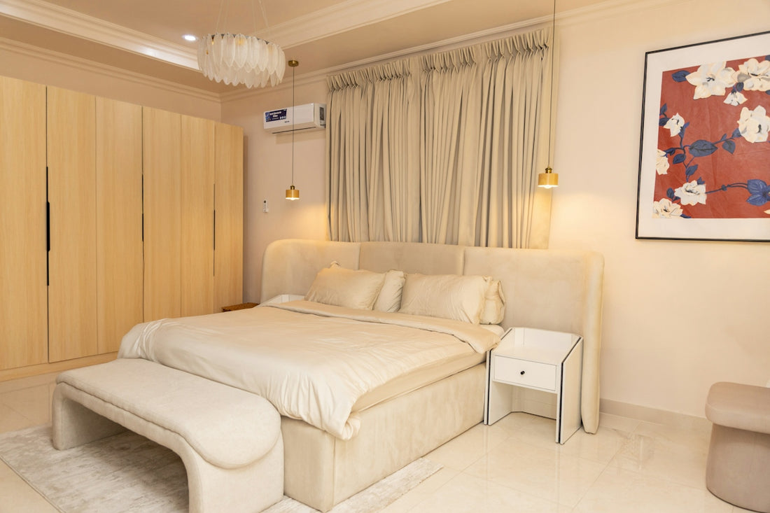 Elegant bedroom featuring a large bed, bench, and neutral decor